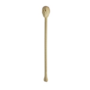 May include: A white plastic skull-shaped stir stick with the text "DINNER & DANCING - CHICAGO" printed on the stick.