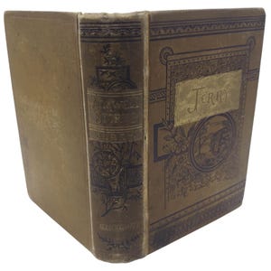 May include: Antique book with a tan cover and spine. The spine reads "Airwell Stories" and "Illustrated". The cover features the title "Jerry" in gold lettering, with an illustration of a scene. The book has a worn appearance.