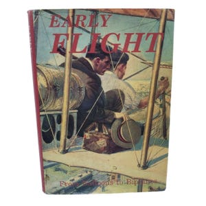 May include: A vintage book titled "Early Flight" with a cover illustration of two men in an early airplane. The cover art features a biplane with the text "From Balloons to Biplanes". The book has a red spine and a colorful illustration.
