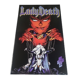 May include: A comic book cover featuring the title "Lady Death" in purple lettering. The artwork depicts a red-skinned demonic figure with long nails controlling a white-haired woman with strings. The background is black.