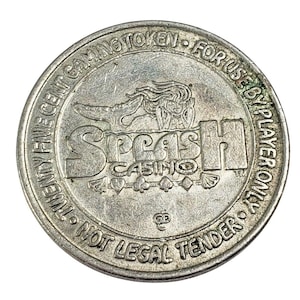May include: Silver-colored casino gaming token with the text "Twenty-five Cent Gaming Token - For Use By Player Only - Not Legal Tender" and the words "Splash Casino" with a mermaid and playing card symbols.
