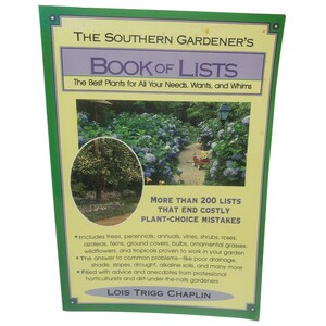 May include: A softcover book titled The Southern Gardener's Book of Lists by Lois Trigg Chaplin. The cover features a light yellow background with a green border, text, and two photographs of a garden with blue hydrangea bushes and a red wagon.