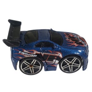 May include: A blue toy race car with a black spoiler. The car has silver wheels and red and white flame graphics. The word "racing" is printed on the side of the car.