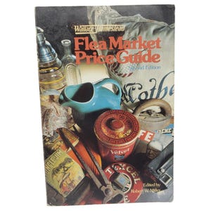 May include: A vintage "Flea Market Price Guide" book cover featuring a collage of antique items. The cover displays the title in red and orange, with a blue pitcher, a red tin, and other collectibles.
