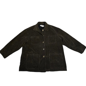 May include: A dark olive green corduroy jacket with a collared neckline, four front pockets, and button closures. The jacket has long sleeves and a relaxed fit, suitable for layering. The corduroy fabric has a ribbed texture.