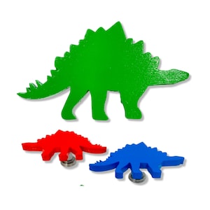 May include: Three wooden dinosaur figurines. The largest dinosaur is green, the middle dinosaur is red, and the smallest dinosaur is blue.