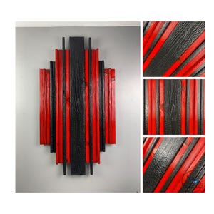 May include: Geometric wooden wall art featuring alternating vertical planks of red and black. The design has a symmetrical, art deco style, with a central column and stepped sides. The wood grain is visible, adding texture to the piece.