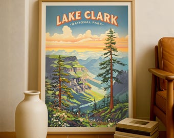 May include: A framed vintage travel poster for Lake Clark National Park. The poster features a scenic landscape with mountains, trees, and a river. The text "Lake Clark National Park" is displayed in orange and white.