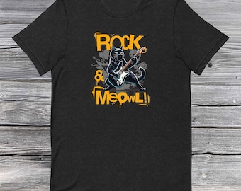 May include: Black t-shirt with a graphic of a black cat playing a guitar. The text "Rock & Meow!" is printed in yellow on the shirt.