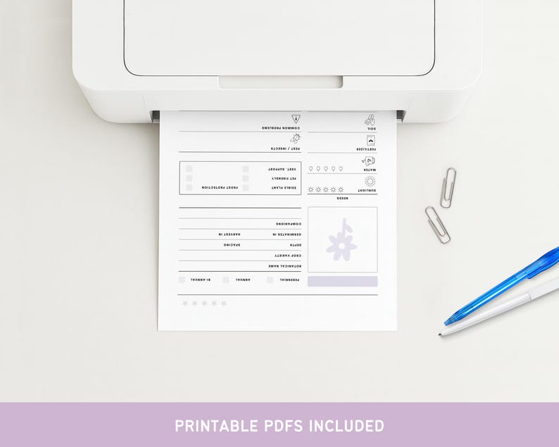 May include: A white printer printing a black and white plant care sheet. The sheet includes sections for common problems, pest/insects, frost protection, and other plant care information. Two silver paper clips and a blue pen are on the white surface.