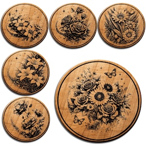 May include: A collection of wooden coasters with floral designs. Each coaster features a different black and white botanical illustration, including roses, lilies, sunflowers, and poppies. The coasters are round and have a dark border.
