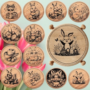 May include: A collection of wooden coasters with engraved Easter-themed bunny designs. Each coaster features a different bunny illustration, some with sunglasses, hats, or holding Easter eggs. The coasters are round with a light wood grain.