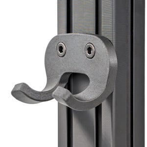 May include: A black plastic hook with two prongs, mounted on a black metal track. The hook has two small screws visible.