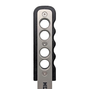 May include: A black and silver manual handbrake with a textured black grip and a silver lever. The grip has six holes for a better grip.