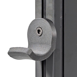 May include: A black plastic handle with a curved shape and a small screw in the center. The handle is attached to a black metal frame.