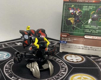 May include: Black and red toy robot with yellow accents. The robot has a butterfly-shaped head and is posed on a black and white circular mat. The robot is a Bakugan toy.