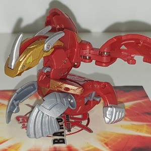 Bakugan Bakugold Pyrus Fusion Dragonoid 890g Mechtanium Surge RAR - Schneller Versand