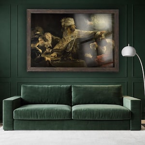 May include: A framed painting depicting a historical scene with figures in ornate clothing. The artwork is displayed above a green velvet sofa, creating a classic and elegant interior design. The painting's frame is dark brown, and the wall is a deep green.