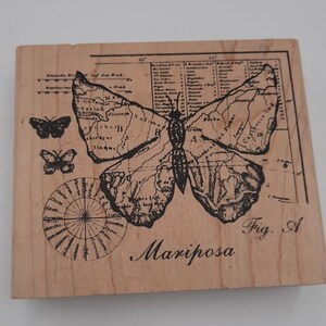 May include: A wooden stamp featuring a butterfly design with map details. The stamp includes the word "Mariposa" and the text "Fig. A". Two smaller butterfly illustrations are also present.