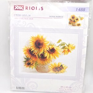 May include: A Riolis cross-stitch kit 1488 titled Hot Summer, featuring a bouquet of yellow sunflowers in a vase with a butterfly. The packaging displays the finished design, wool/acrylic materials, and dimensions of 15 3/4 by 11 3/4 inches.