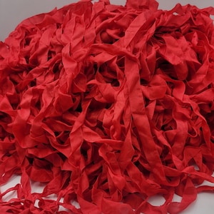 May include: A large pile of red fabric ribbon, perfect for crafting and DIY projects.