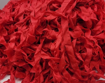 May include: A large pile of red fabric ribbon, perfect for crafting and DIY projects.