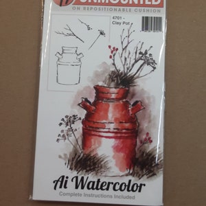May include: A clear stamp set featuring a watercolor illustration of a red clay pot with branches and berries. The stamp set is unmounted and comes on a repositionable cushion. The text "Art Impressions Unmounted" and "4701 - Clay Pot" is printed on the packaging.