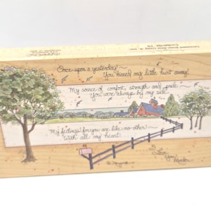 May include: Wooden plaque with a painted landscape scene featuring a red-roofed house, trees, and a fence. The plaque has handwritten text with phrases like "Once upon a yesterday" and "My feelings for you are like no other."