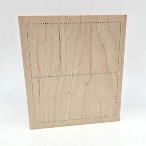 May include: A rectangular wooden stamp with three rectangular dotted-line frames. The stamp is made of light-colored wood and has a natural wood grain pattern. The dotted lines create a grid-like design.