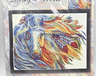 May include: A Design Works 14 inch by 18 inch counted cross stitch picture kit titled War Horse. The packaging features a colorful illustration of a horse with flowing mane and feathers, including Aida cloth, floss, needle, and instructions.
