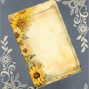 May include: A gray frame with a beige background features sunflowers and decorative floral accents. The frame's design includes a vintage-style paper insert with lined space for writing or notes. The sunflowers are realistically rendered, adding a touch of natural beauty to the frame's design. The frame is perfect for adding a rustic or farmhouse touch to any home decor.