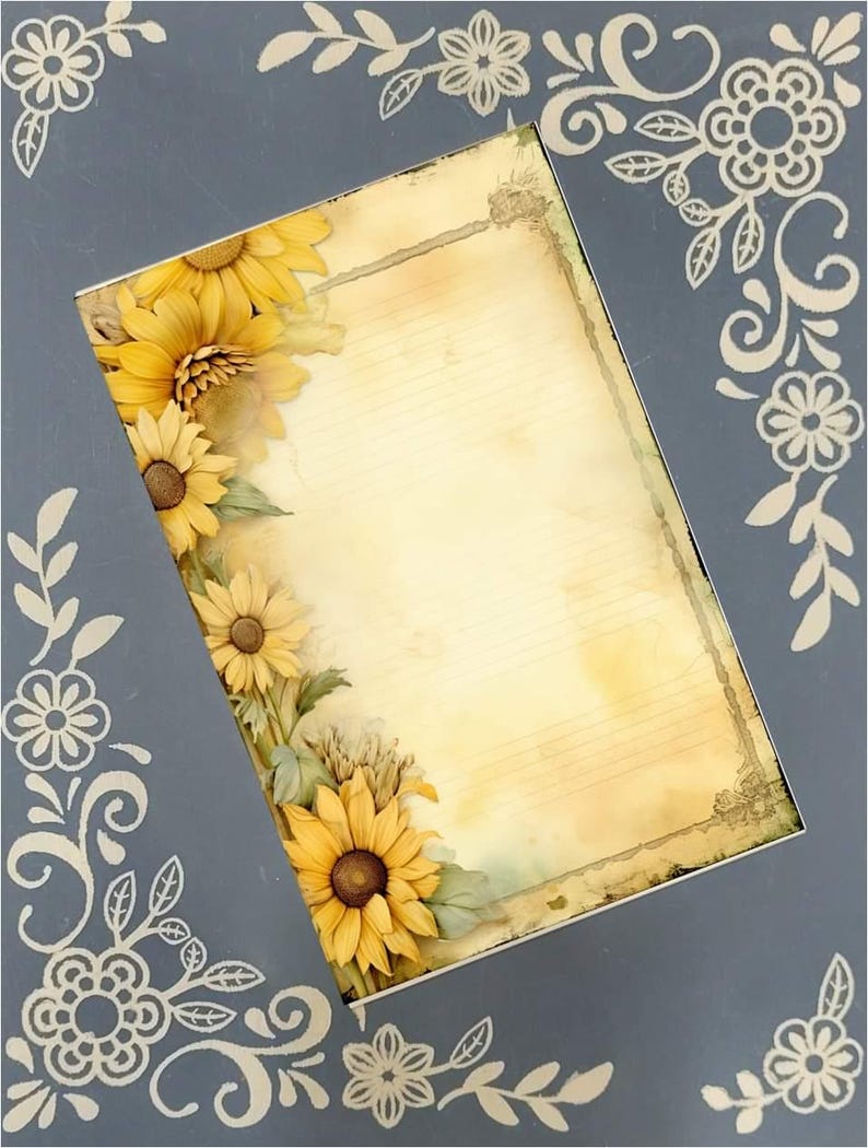 May include: A gray frame with a beige background features sunflowers and decorative floral accents. The frame's design includes a vintage-style paper insert with lined space for writing or notes. The sunflowers are realistically rendered, adding a touch of natural beauty to the frame's design. The frame is perfect for adding a rustic or farmhouse touch to any home decor.