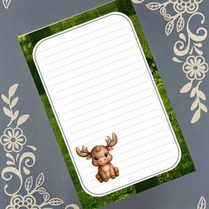 May include: A lined notepad with a green patterned border and a cartoon moose illustration. The notepad has a white interior with horizontal lines for writing. Decorative floral elements are in the corners.