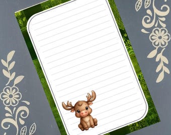 May include: A lined notepad with a green patterned border and a cartoon moose illustration. The notepad has a white interior with horizontal lines for writing. Decorative floral elements are in the corners.