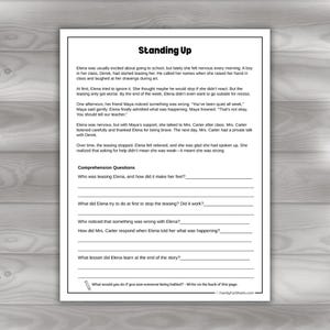 May include: A black and white worksheet titled "Standing Up" with comprehension questions about bullying. The text describes a story about a girl named Elena who is being teased at school. The worksheet is from FamilyFunSheets.com.