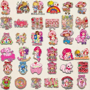 May include: A collection of colorful Strawberry Shortcake stickers and decals. The designs feature the character in various poses, with friends, and with text like "Made in the 80's" and "Strawberry Baby". The stickers are in shades of pink, red, and blue.