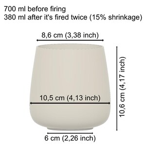 May include: A beige ceramic vase with a rounded base and a wide opening. The vase is 10.6 cm tall, 10.5 cm wide, and 6 cm in diameter at the base. The text indicates the vase shrinks after firing.