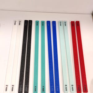 May include: A set of ten sanding sticks in various colors and sizes, ranging from 2 mm to 7 mm. The sticks are labeled with their respective sizes in millimeters.