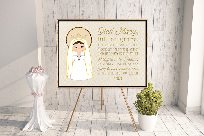 May include: A printable wall art print featuring a gold-framed image of the Virgin Mary with a crown and a white dress. The print includes the text "Hail Mary, full of grace, THE LORD IS WITH THEE: Blessed art thou among women AND BLESSED IS THE FRUIT of thy womb, Jesus. HOLY MARY, MOTHER OF GOD pray for us sinners now & AT THE HOUR OF OUR DEATH. AMEN."