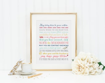 May include: A framed print with a white background and colorful text that reads: "May today there be peace within. May you trust God that you are exactly where you are meant to be. May you not forget the infinite possibilities that are born of faith. May you use those gifts that you have received, and pass on the love that has been given to you. May you be content knowing you are a child of God. Let this presence settle into your bones, and allow your soul the freedom to sing, dance, praise and love. It is there for each & every one of us."