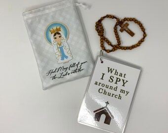 May include: A white fabric bag with a blue and white image of the Virgin Mary. The bag is next to a wooden rosary with a brown cross. A white card with the text "What I SPY around my Church" and a small church image is also included.