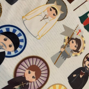 May include: A collection of colorful paper cutouts depicting various religious figures. Each figure is surrounded by a decorative halo and features a unique design. The figures include a woman in a white veil, a man in a black robe, a woman in a blue robe, and a man in a gray robe.