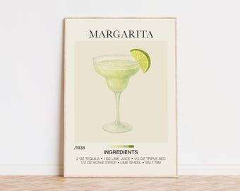 Op de afbeelding: Een ingelijste print met een aquarel illustratie van een margarita cocktail. De drank zit in een glas met een zoutrand en een schijfje limoen. Het woord "MARGARITA" staat bovenaan, met de ingrediënten eronder.