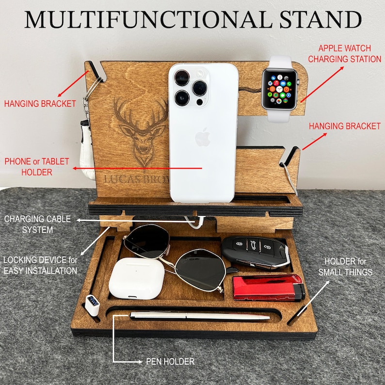 May include: Wooden stand with multiple compartments for organizing items. It features a phone or tablet holder, a charging cable system, a pen holder, a holder for small things, and a charging station for an Apple Watch. The stand is personalized with the name "Lucas Bro".