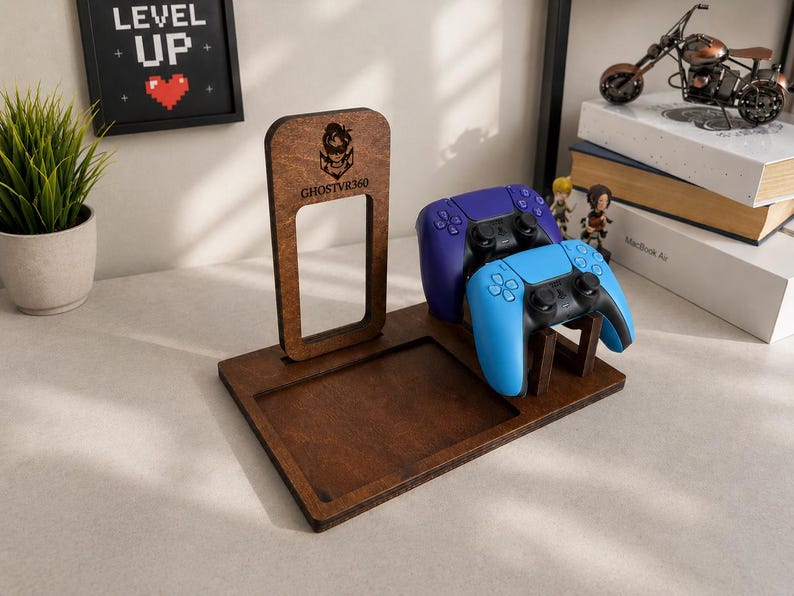 May include: A dark brown wooden gaming controller stand featuring a rectangular base with a recessed tray and an upright support panel. The panel displays a laser-engraved logo and the text GHOSTVR360. Two wireless controllers are mounted on the stand.