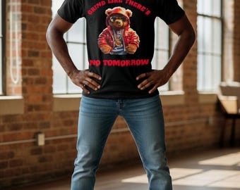 May include: Black t-shirt with a graphic of a bear wearing a red jacket and gold chain, with the text "GRIND LIKE THERE'S NO TOMORROW" in red. The person is wearing blue jeans and white sneakers.
