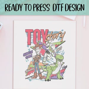 May include: A white square DTF design featuring the words "TOY STORY" in pink and yellow, with Woody, Buzz Lightyear, and Rex the dinosaur. The design includes the text "SINCE 1995" and "READY TO PRESS DTF DESIGN" in black.