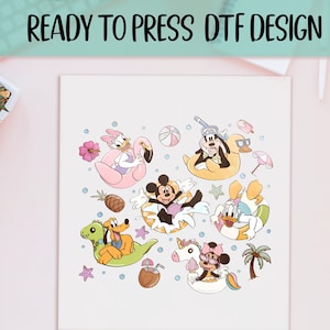 May include: A white print featuring cartoon characters in inflatable pool floats, including Mickey Mouse, Donald Duck, and Daisy Duck. The design includes beach-themed elements like a pineapple, palm tree, and beach ball. Text at the top reads "READY TO PRESS DTF DESIGN."