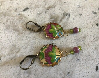 Recycled tin earrings featuring purple flowers