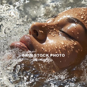 May include: Close-up of a person's face with water droplets on their skin. The person's eyes are closed and their lips are slightly parted. The background is blurred and out of focus.